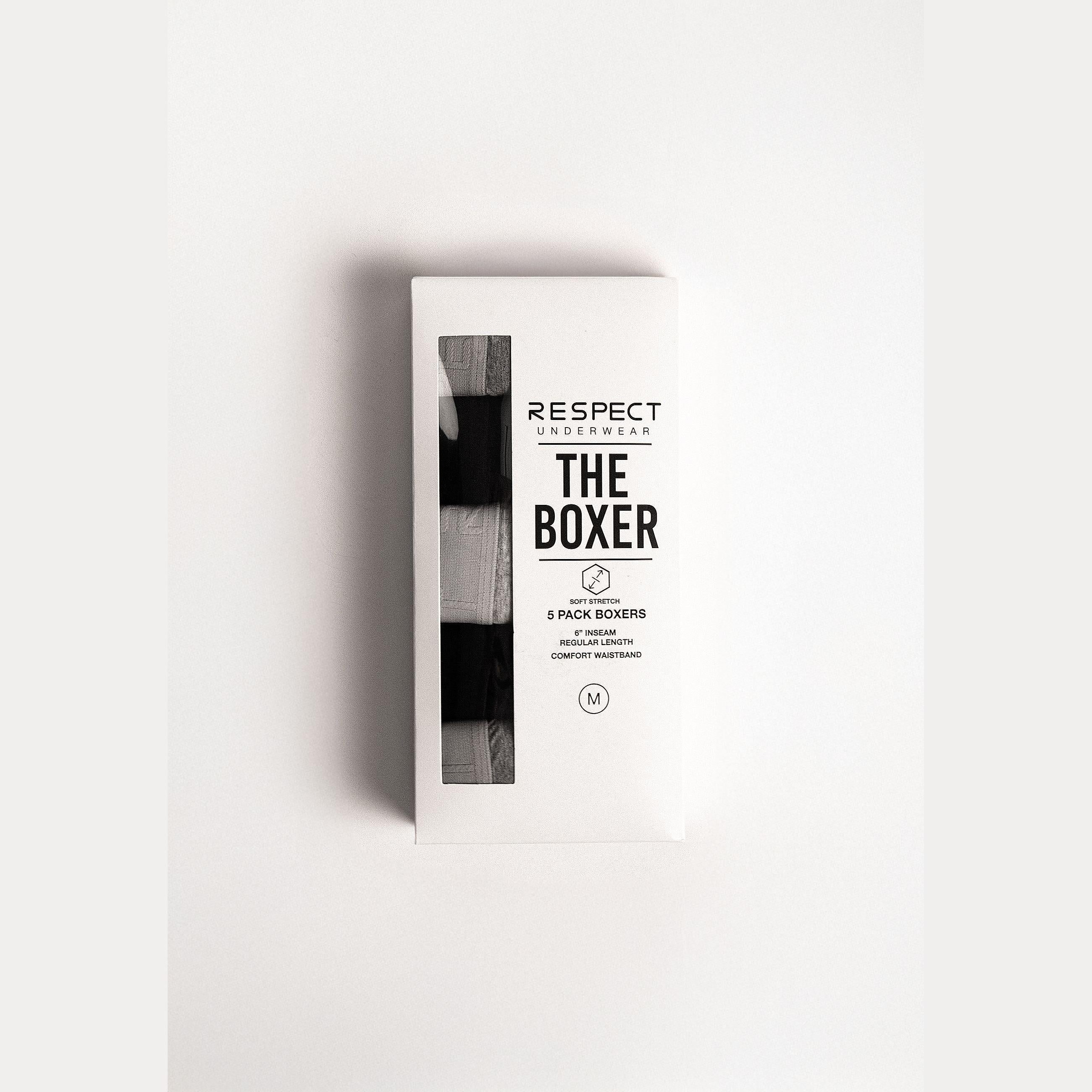 Single black cotton boxer shorts with elastic waistband and functional fly opening on white background