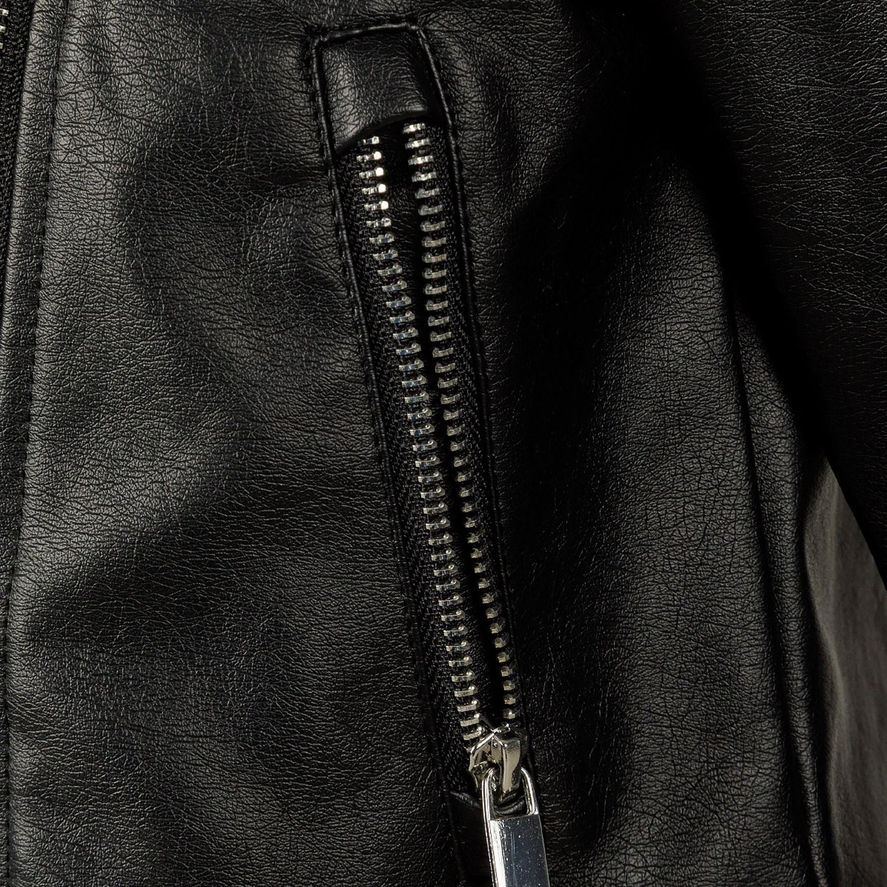 Close-up detail of silver zipper on black faux leather biker jacket showing metallic hardware and leather texture