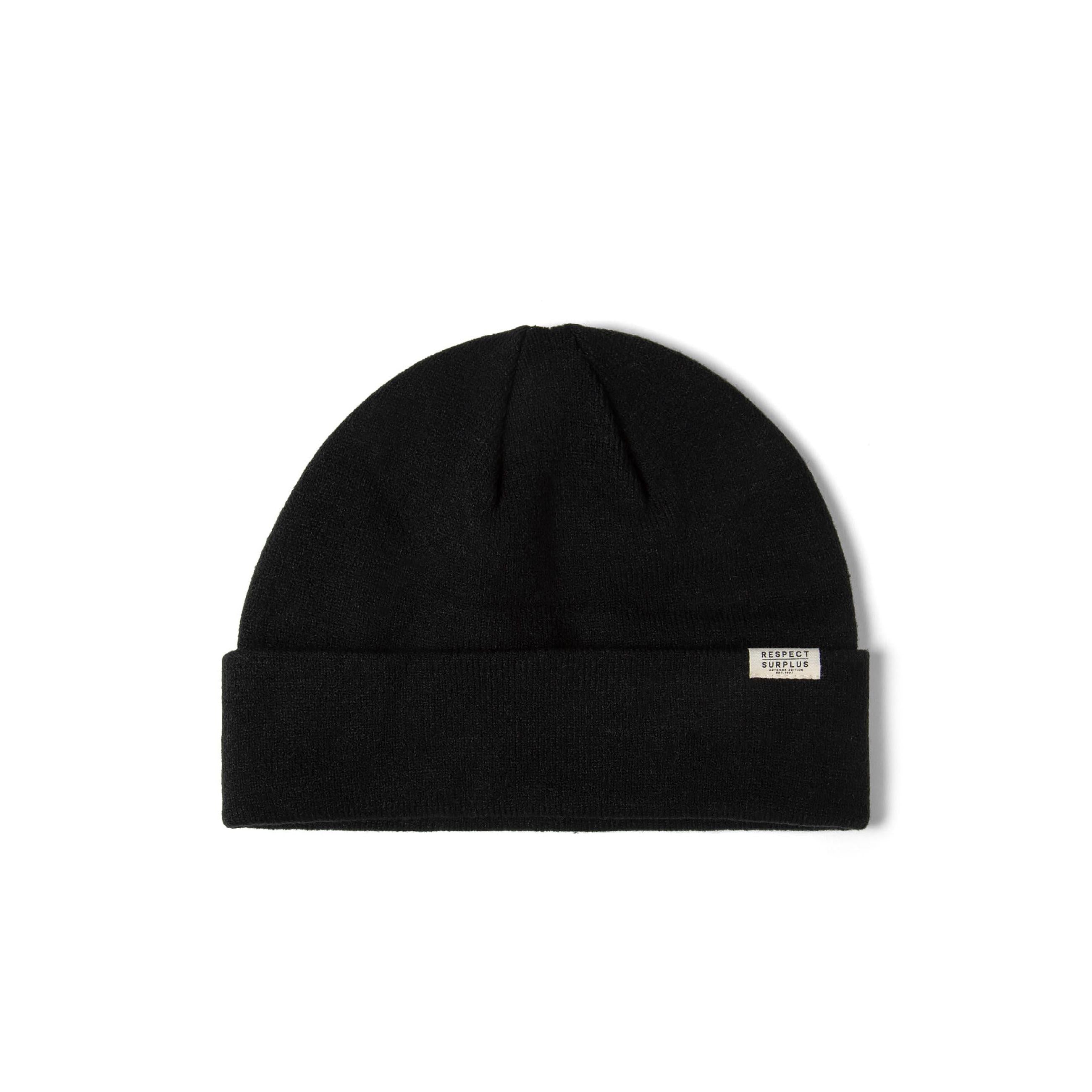 Single brown ribbed beanie hat with fold-up cuff and white brand label displayed flat on white background