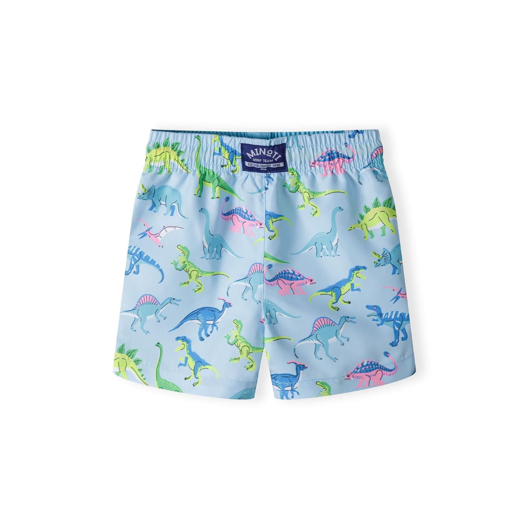 Back view of light blue board shorts showing dinosaur print pattern and Minoti label on waistband, displayed flat on white background