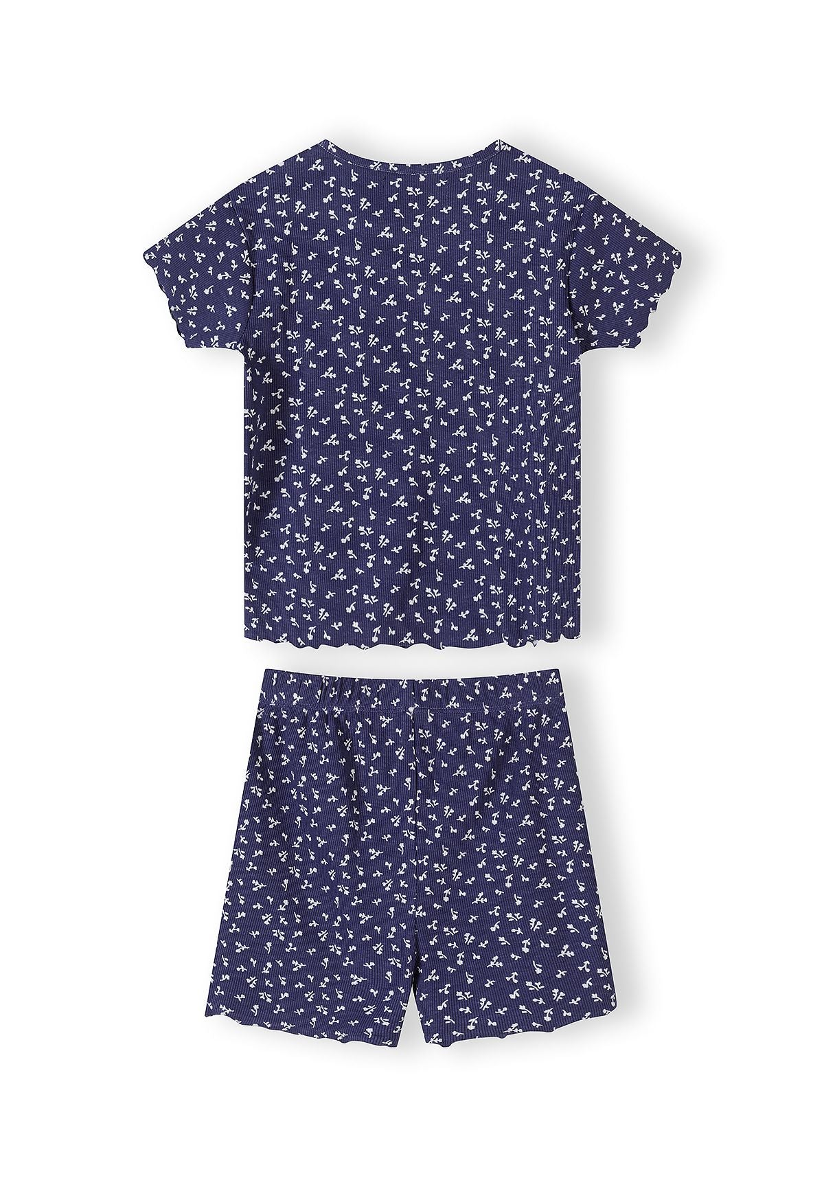 Close-up detail of white ribbed fabric with navy floral print pattern showing Minoti brand label