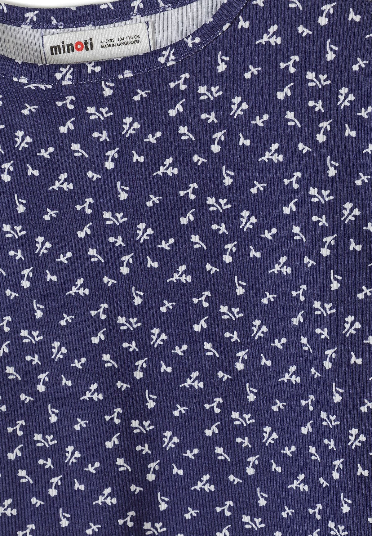 Close-up detail of white ribbed fabric with navy floral print pattern showing Minoti brand label