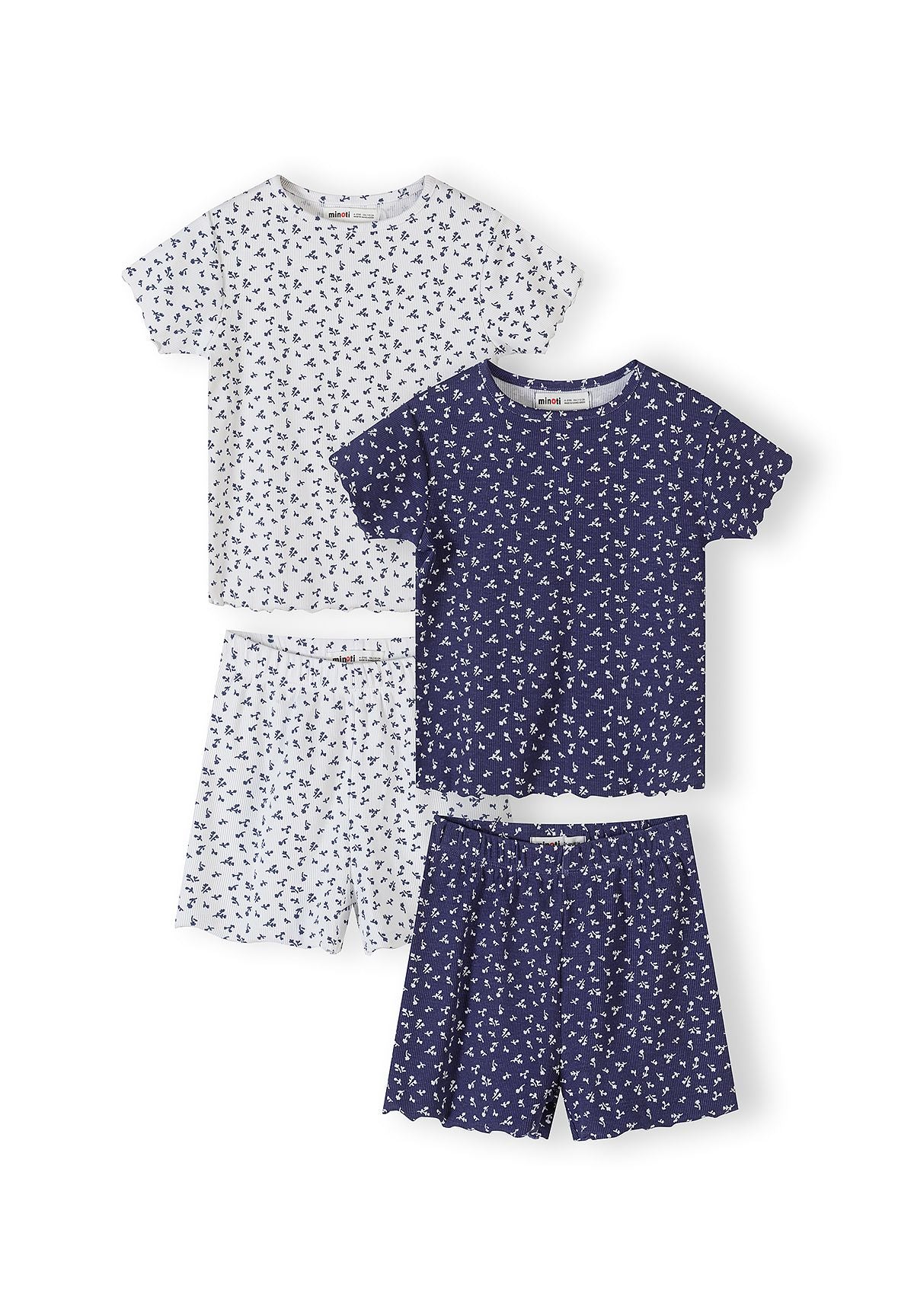 Two ribbed pyjama sets laid flat - one navy with white floral print, one white with navy floral print, each with matching shorts on white background