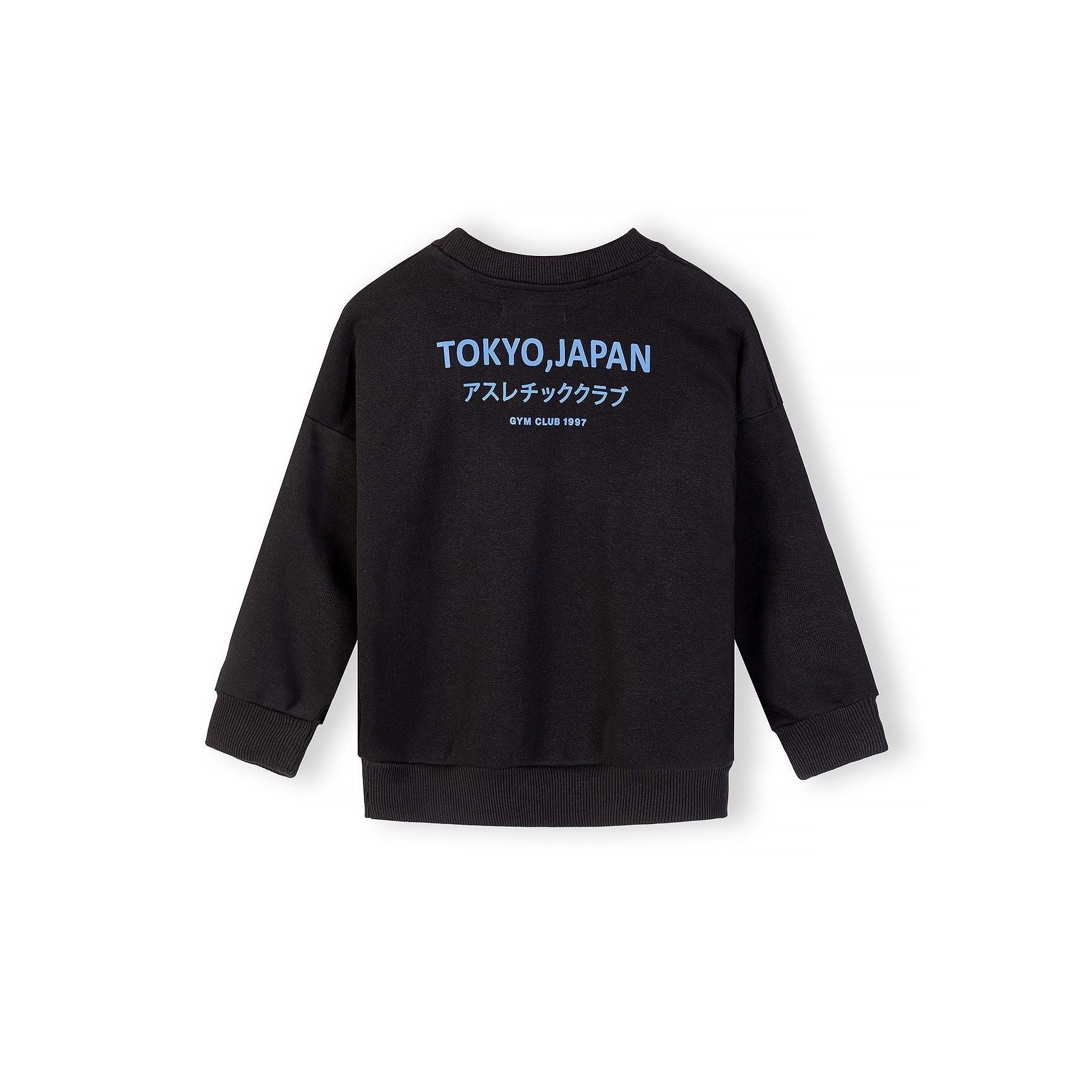 Close-up view of black cargo shorts showing elasticated waistband with drawstring and side cargo pocket details on white background