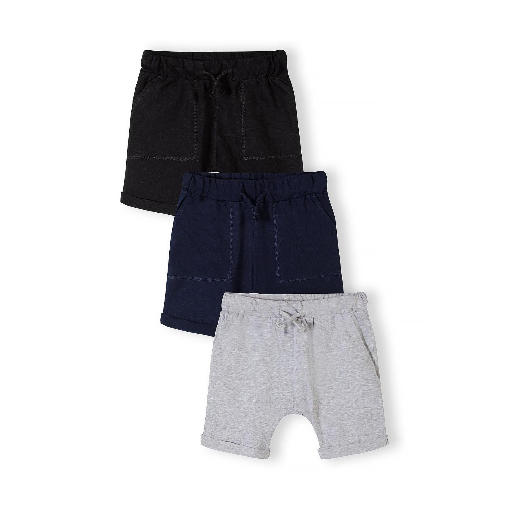 Three cotton slub jersey shorts laid flat showing navy, grey and black colours with elasticated waistbands and rolled cuffs on white background