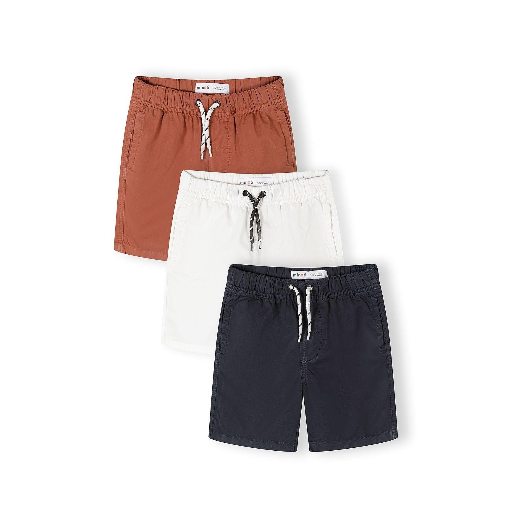 Three boys shorts in navy, white and ochre colours laid flat against white background showing elastic waistbands with drawstring ties