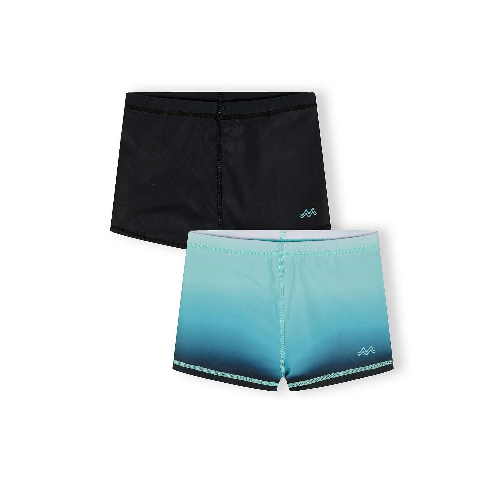 Two pairs of swim shorts displayed flat - solid black pair above and blue gradient ombre pair below, both featuring small mountain wave logos on white background
