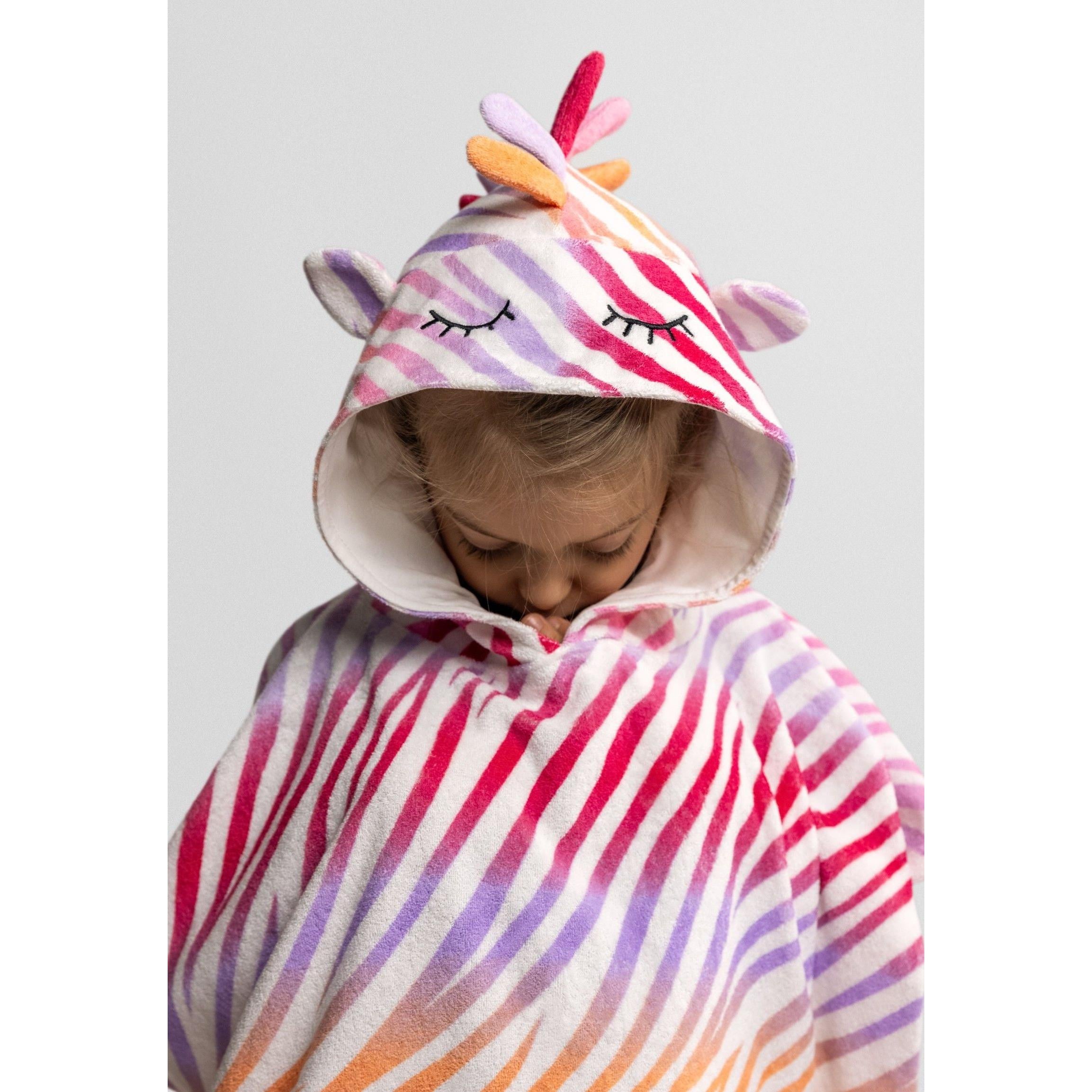 Flat lay of rainbow zebra stripe hooded towelling cover-up showing full poncho design with colourful hood spikes against white background