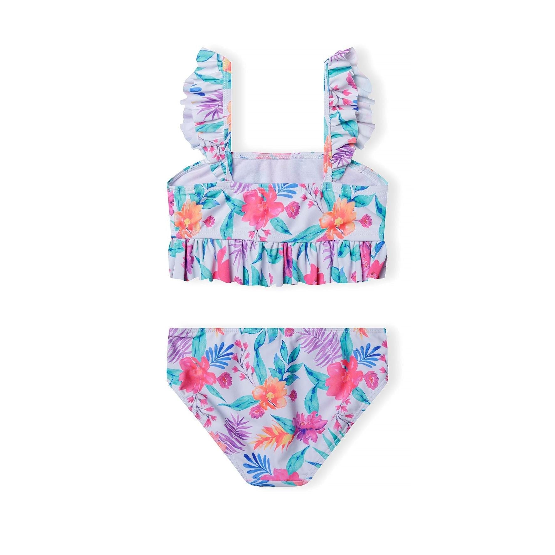 Close-up view of tropical floral bikini top with ruffled shoulder straps showing detailed hibiscus and palm leaf pattern on white background