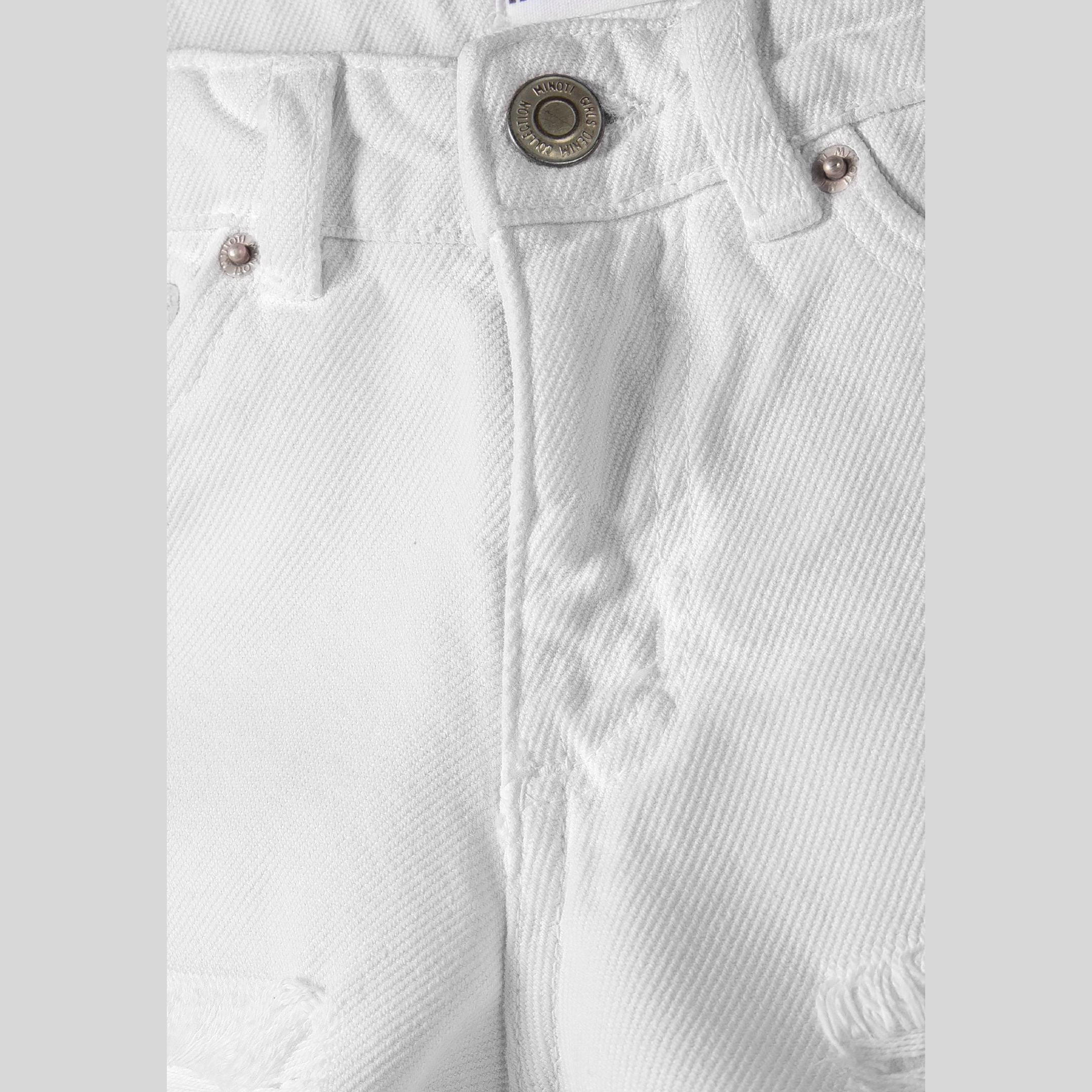 Close-up detail of white denim shorts showing front waistband, button closure, and textured denim fabric