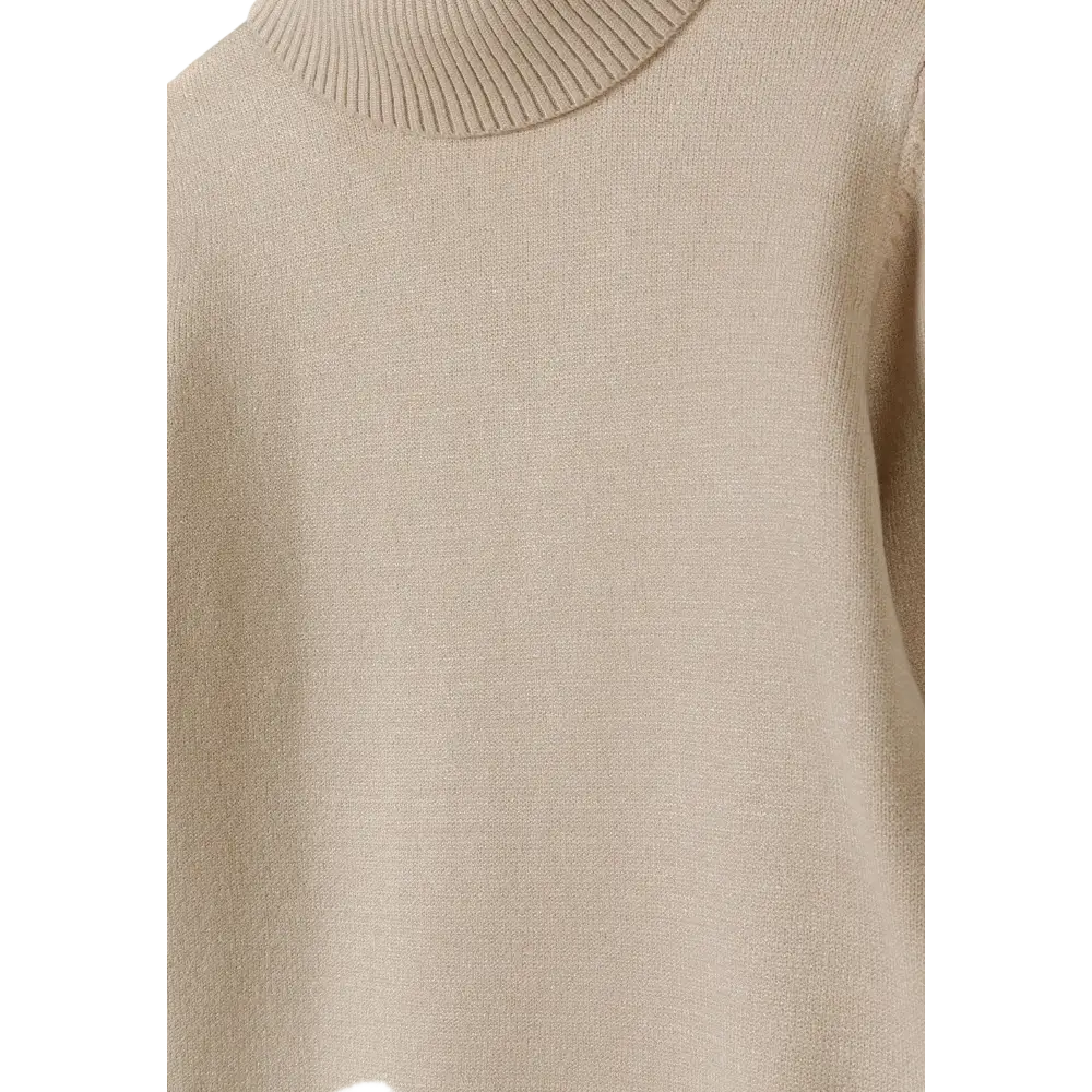 Close-up detail of beige fine knit turtleneck showing texture and fold-over collar construction against black background