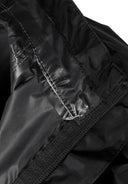 Close-up of black waterproof jacket seam with taped waterproof design and fitted cuff detail