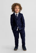 Young boy wearing navy blue slim fit formal trousers and matching blazer with a tie, showcasing stylish kids fashion design.