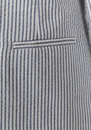 Close-up of tailored navy blue striped cotton fabric pocket detail on boys' blazer with a sleek design.