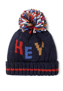 Navy knitted hat with multicolored pom pom and jacquard wording detail, front view.