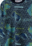 Close-up of navy boys' pyjama top featuring a geometric pattern and text.