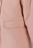 Detail of a pink girls' padded coat showing a patch pocket.