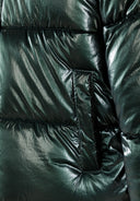 Detail of a green padded jacket with stitched detailing and a side pocket.