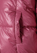 Detail of a padded reversible jacket in metallic purple with a front zip and ribbed cuffs.