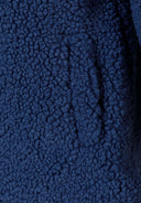Detail of blue sherpa boucle fabric with a soft texture.
