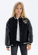 Boys baseball jacket in black, front view with faux leather sleeves and ribbed cuffs.