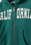 Close-up of a green girls zip-through hoodie featuring a decorative front print and ribbed cuffs.