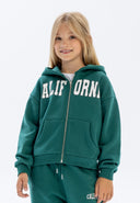 Girls zip-through hoodie in green with front print, featuring a hood and ribbed cuffs.