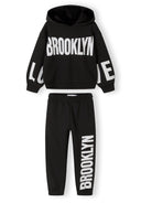 Girls hooded tracksuit in black, featuring printed details, front view.