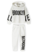 Girls hooded tracksuit in white with printed accents, featuring a relaxed fit and kangaroo pocket.
