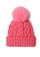 Close-up of a pink knitted cable hat with a pom pom on top.