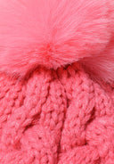 Close-up of a pink knitted cable hat with a pom pom on top.