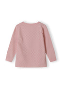 Back view of a pink long sleeve pyjama top with white polka dots and ribbed cuffs.