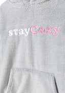 Detail of a grey girls oversized hoodie with a hood and kangaroo pocket, featuring 'stayCosy' embroidery.