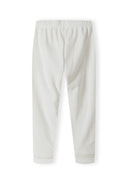 Detail of girls' cream velour pyjama bottoms with elasticated waistband and ribbed cuffs.