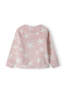 Back view of a girls' pink pyjama top with white star pattern and raglan sleeves.
