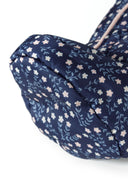 Detail of a navy baby snowsuit with floral print and attached mitts.