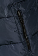 Detail of navy men's jacket with zippered pocket and fleece lining.