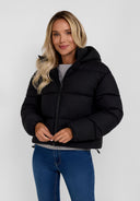 Close-up of a black short quilted jacket for women with a hood and high collar.