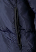 Detail of a navy long quilted winter jacket with a zipper.