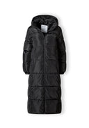 Long black quilted winter jacket with drawstring hood, front view, featuring a full-length zipper and zipped pockets.