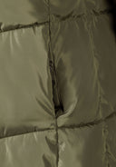 Detail of a khaki quilted winter jacket with a pocket.