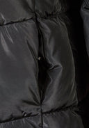Detail of a black quilted winter jacket showing padding and stitching.