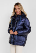 Close-up of a women's navy quilted short hooded jacket with zip and flap pockets.