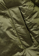 Detail of olive padded jacket showing quilted texture and stitching.