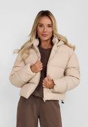 Women short quilted jacket with hood, front view, features a full-length zipper and elasticated hem.