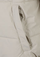 Detail of a men's grey ripstop jacket showing the pocket opening.