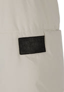 Detail of a men's ripstop jacket featuring a logo badge.