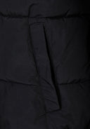 Close-up of a black ripstop jacket showing a zippered pocket and quilted texture.