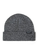 Grey knit beanie with fold-up hem and logo badge, close-up.
