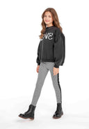 Girls leggings dogtooth with side panels black 3-14y feature a trendy dogtooth pattern, crafted from soft knitted fabric for comfort.